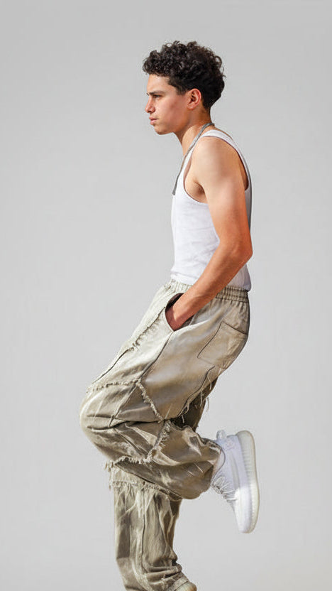 Person leaning against a wall on a city street