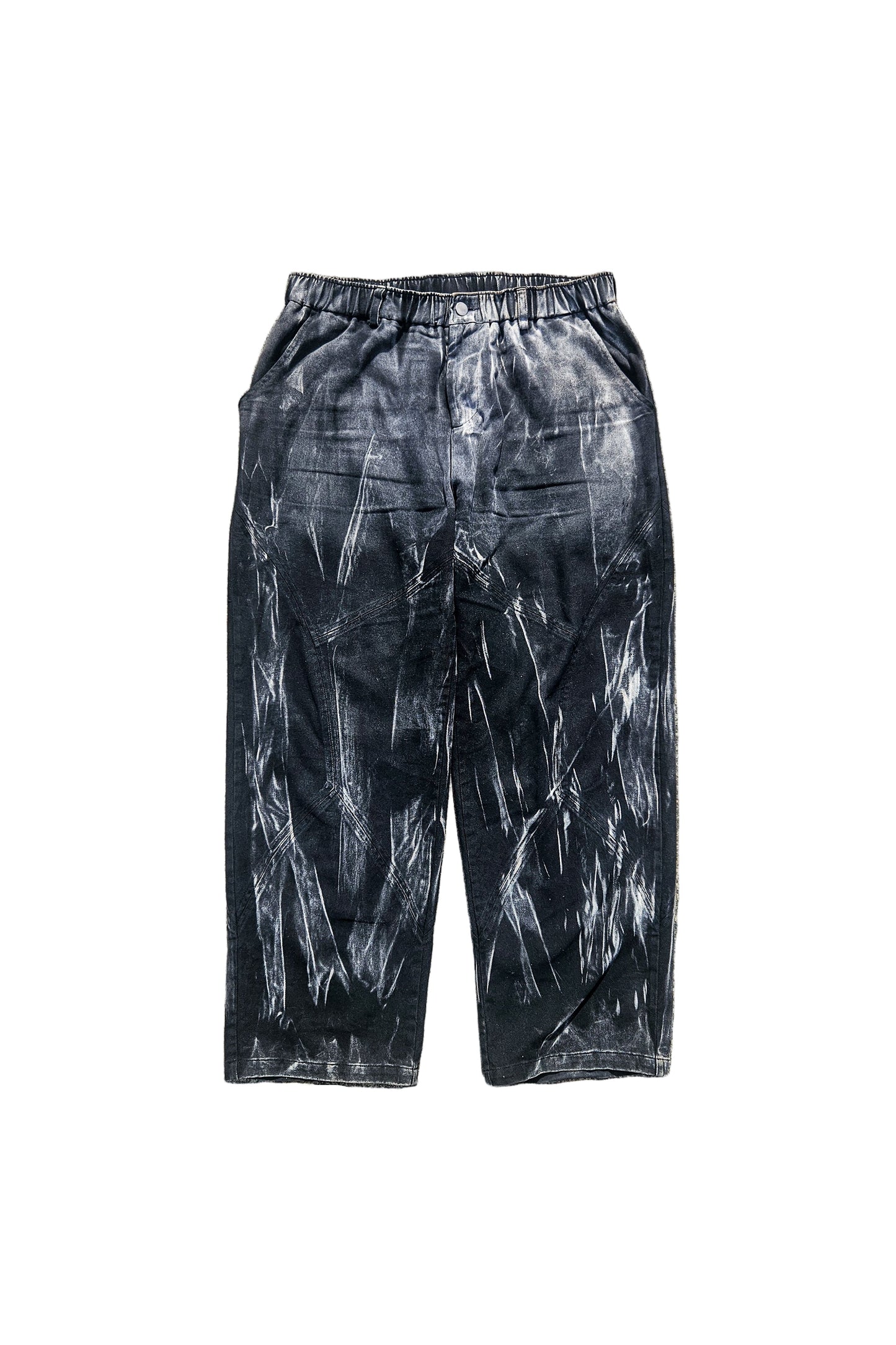 Black tie-dye pants on a concrete surface