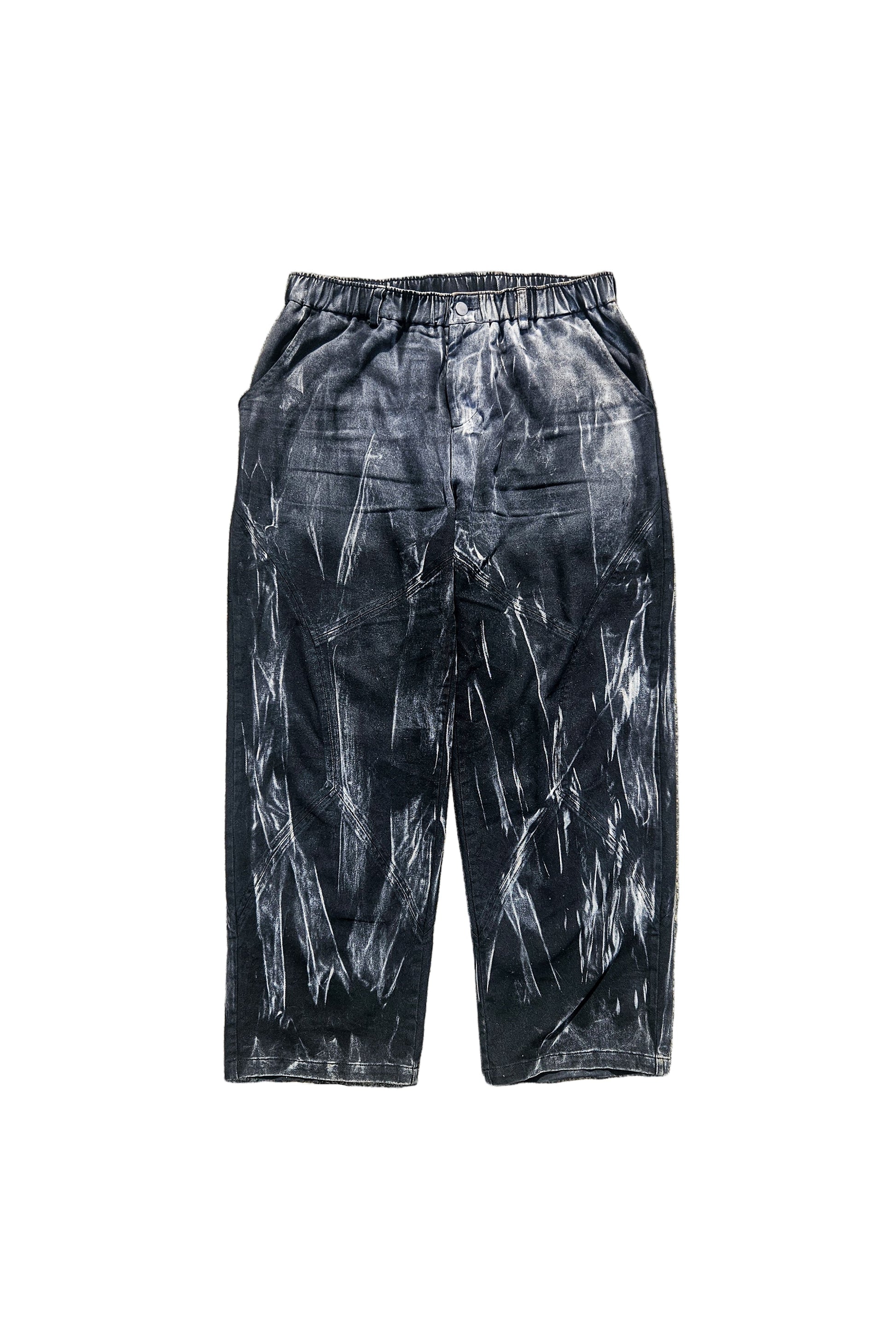 Black tie-dye pants on a concrete surface