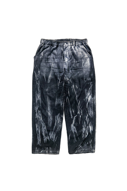 Black tie-dye pants on a concrete surface