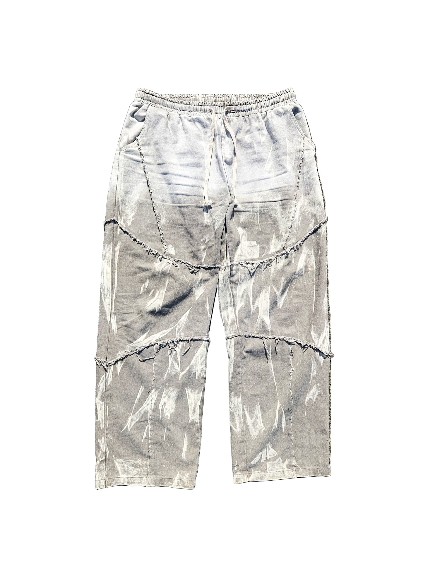 Gray tie-dye pants on a textured brown surface