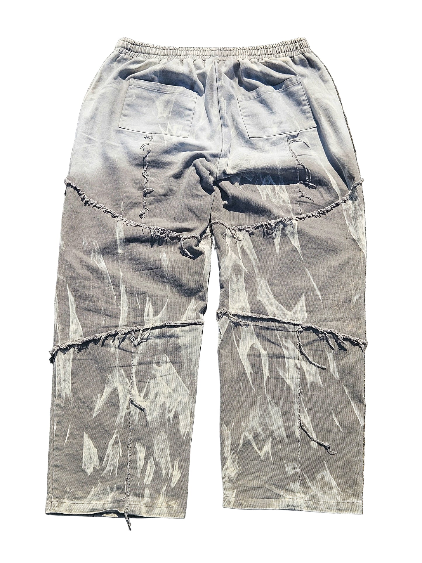 Light blue distressed cargo pants on a gray surface