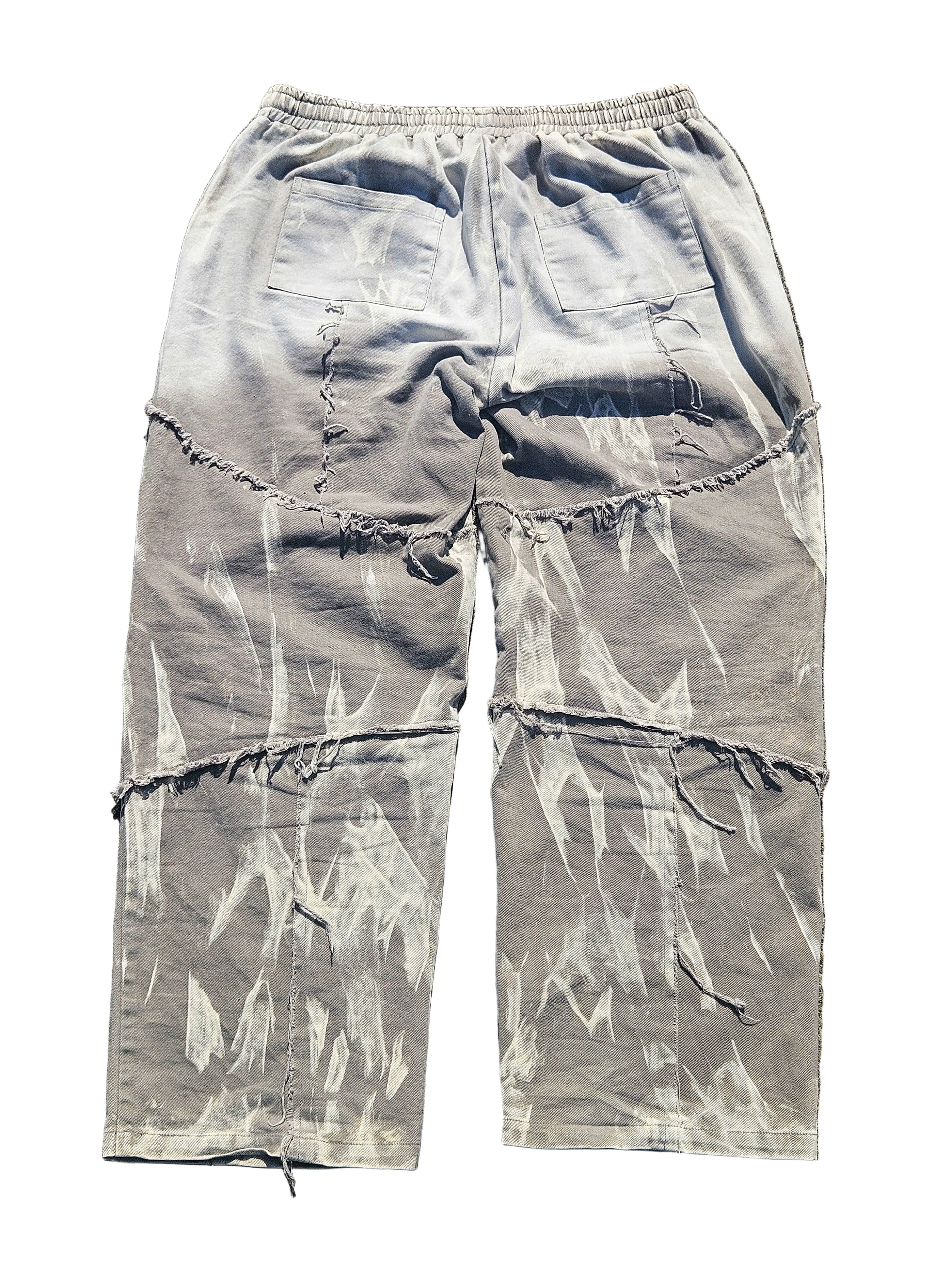Light blue distressed cargo pants on a gray surface