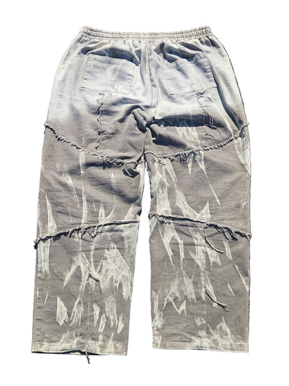 Light blue distressed cargo pants on a gray surface
