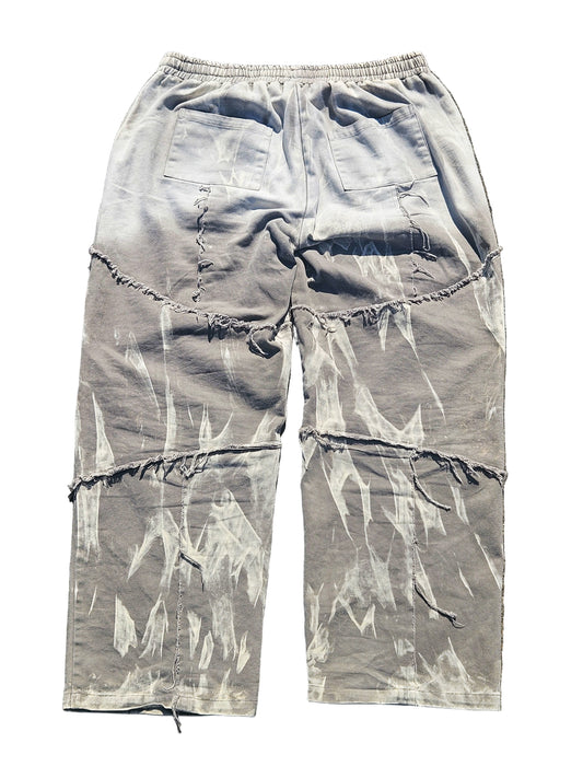 Light blue distressed cargo pants on a gray surface