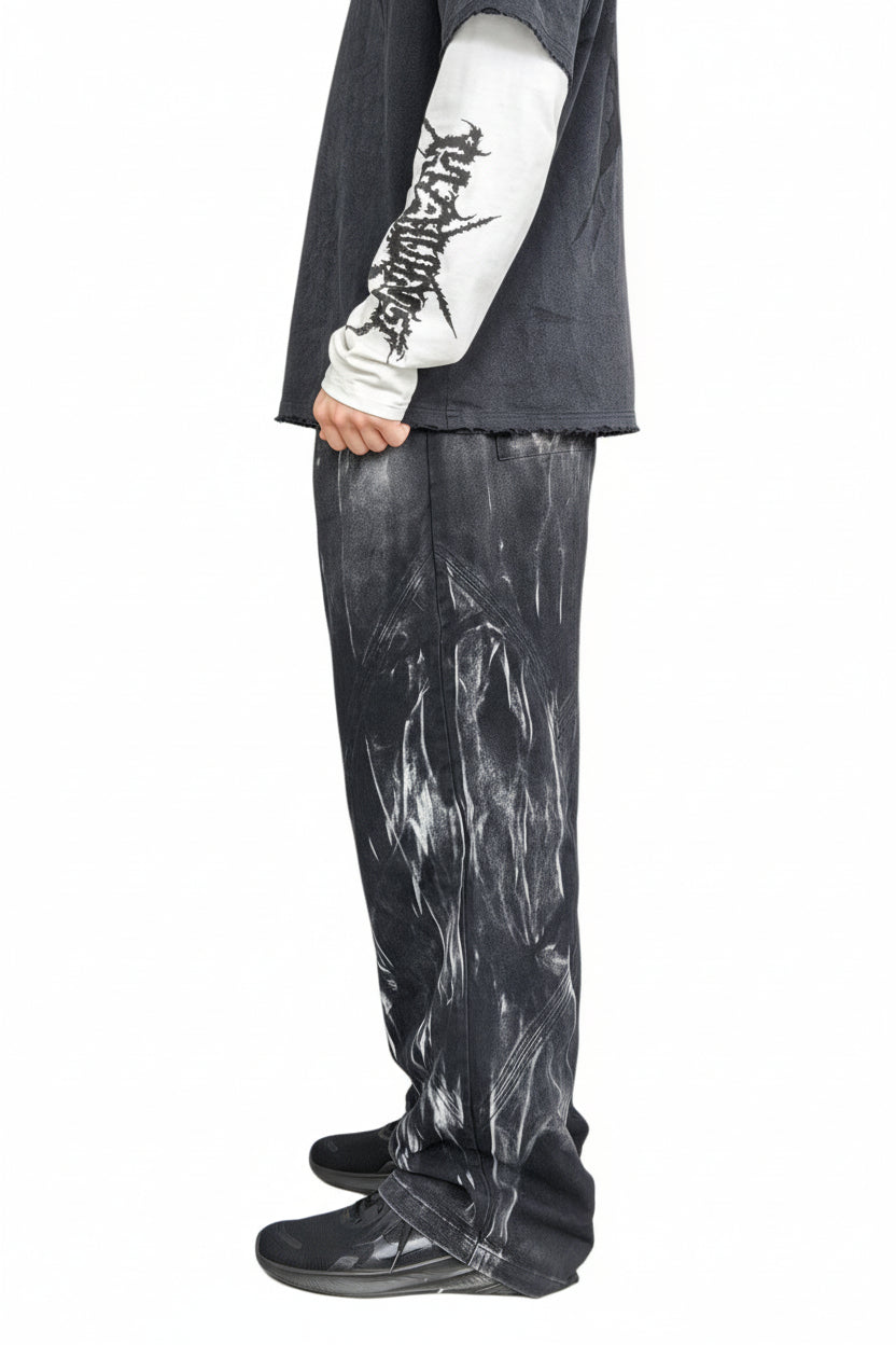 Person wearing a dark outfit with a tattoo on an urban background