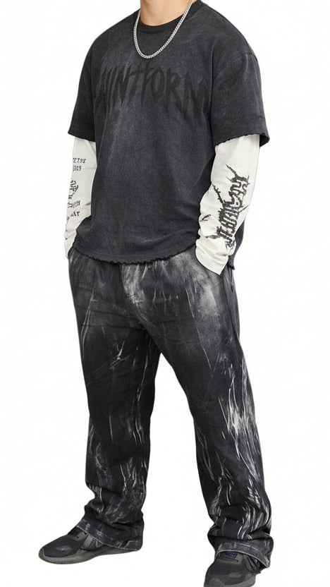 Person wearing a dark jacket with a graphic design on a black background