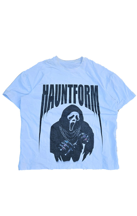 Light blue t-shirt with black graphic design on a gray surface