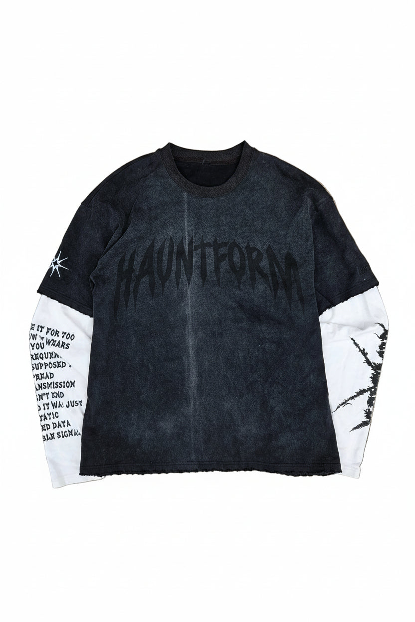 Black and white jacket with text design on a beige surface