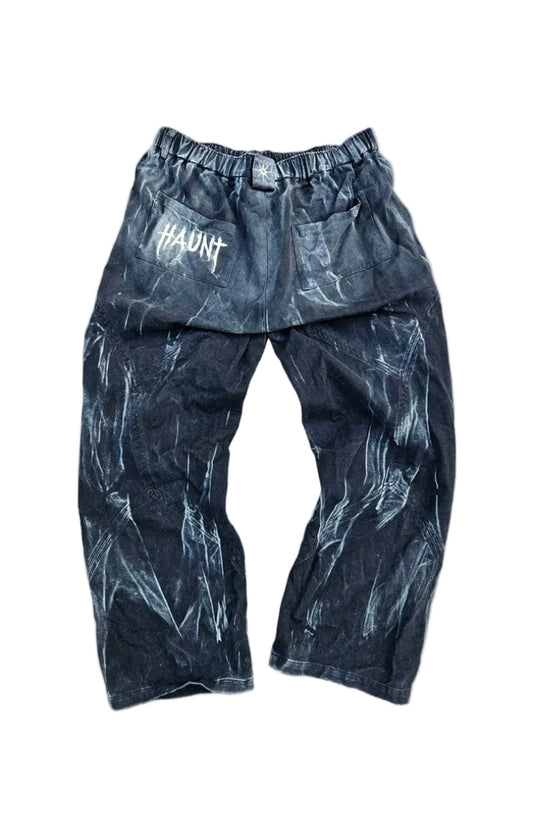 Dark pants with a pattern on a gray concrete surface